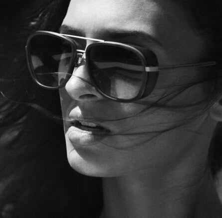 Black and white photo of woman wearing oversized retro square aviator sunglasses – unisex fashion eyewear with bold frame