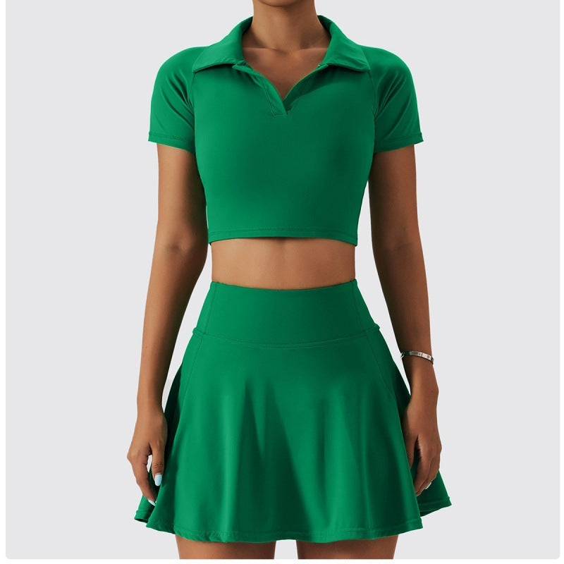 Woman modeling a vibrant emerald green athletic skirt set with a cropped polo top and A-line mini skirt.