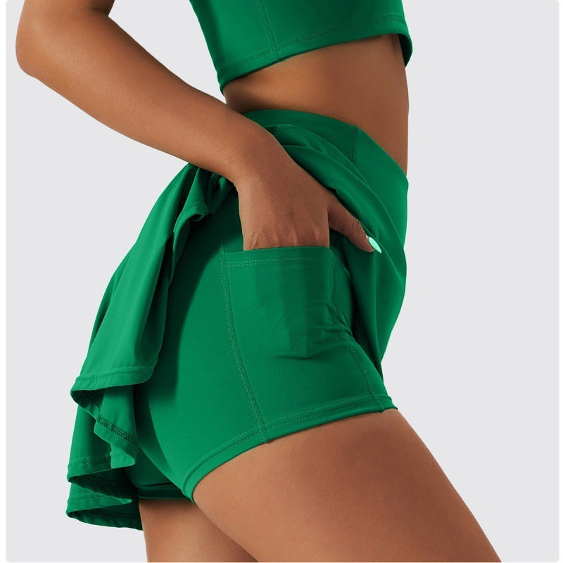  Close-up of the built-in shorts and side pocket detail under green flared tennis skirt.