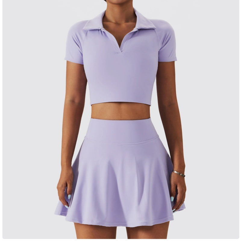 Front view of a lavender tennis outfit with a sleek cropped collared top and matching mini skirt.