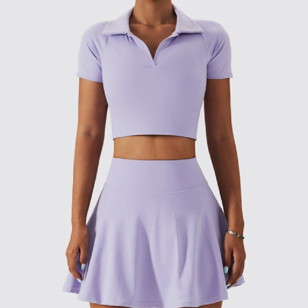  Woman wearing a lavender two-piece tennis outfit featuring a collared crop top and flared mini skirt