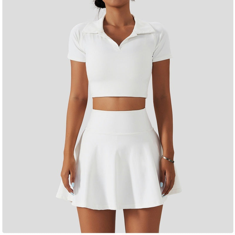  All-white tennis outfit featuring a short-sleeve collared crop top and matching mini skirt.